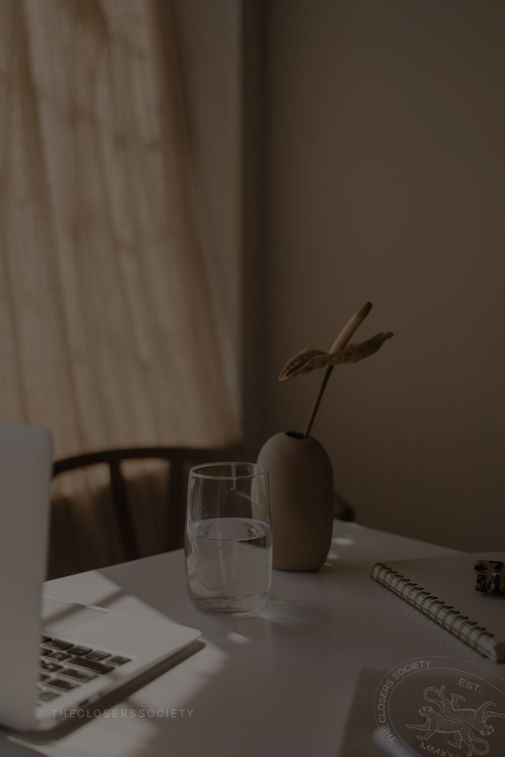 Table with macbook water and vase